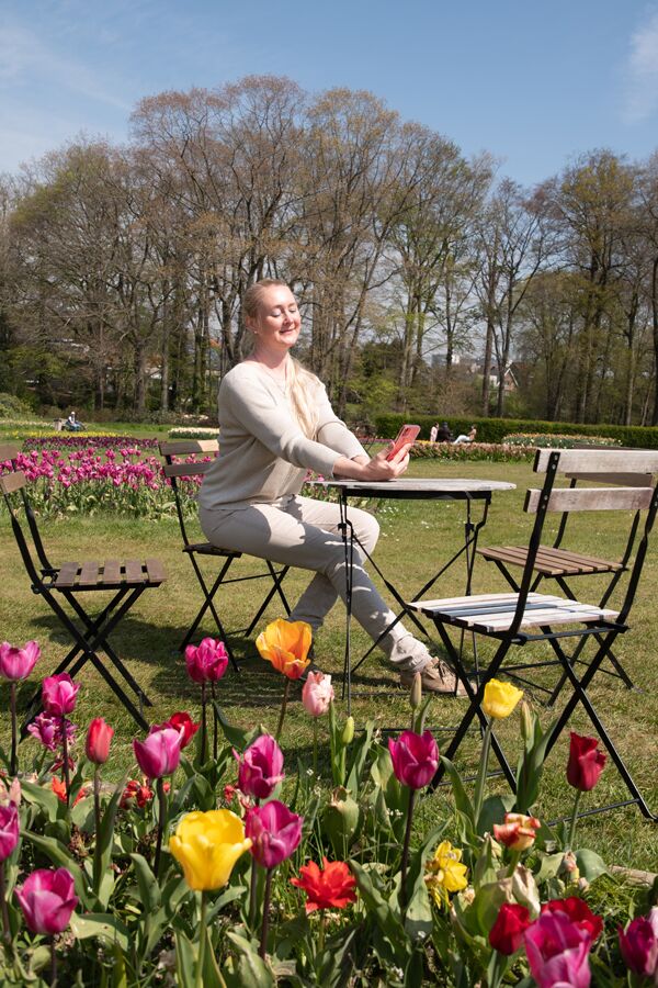 young beautiful blond woman in trendy suit in park